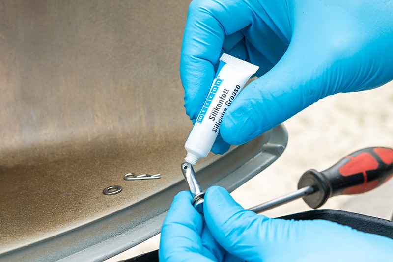 silicone grease, grease tube, car maintenance, metal surface, screwdriver tool